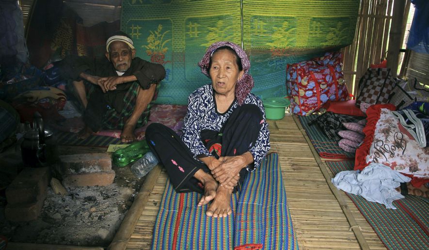 In this May 6, 2018, photo, ethnic Kachin Nlam Numrang Doi, 92, sits along with her husband Hkaraw Yaw, 102, at their hut in compound of Trinity Baptist Church refugee camp for internally displaced people in Myitkyina, Kachin State, northern Myanmar. Myanmar's army, notorious for perpetrating violence that drove 700,000 Muslim ethnic Rohingyas to flee to neighboring Bangladesh, now stands accused of fostering a similar humanitarian crisis in the country's north, where it battles guerrillas of the Christian Kachin minority. (AP Photo/Min Kyi Thein)