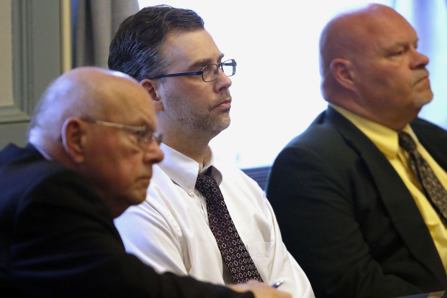 Shawn Grate, center, sits between his attorneys Robert, left, and Rolf Whitney before Judge Ronald P. Forsthoefel during a trial in Ashland, Ohio, Monday, May 7, 2018. Grate was convicted Monday in the slayings of two women whose bodies were found underneath piles of clothes in what was thought to be a vacant Ohio home. (Tom E. Puskar/The Times Gazette via AP)