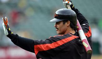 FILE - In this Aug. 15, 2005, file photo, Baltimore Orioles&#39; Rafael Palmeiro waves to fans as he prepares to take batting practice for the team&#39;s baseball game against the Oakland Athletics in Oakland, Calif. Palmeiro says he has agreed to play with his son for the independent Cleburne (Texas) Railroaders at age 53. Palmeiro told the Dallas Morning News in a text Tuesday that he is looking forward to joining the second-year American Association team and will be teammates with his 28-year-old son Patrick. “Nobody gave me a chance to go to spring training, so I will just take this path,” Palmeiro said in the text. (AP Photo/Marcio Jose Sanchez, File)