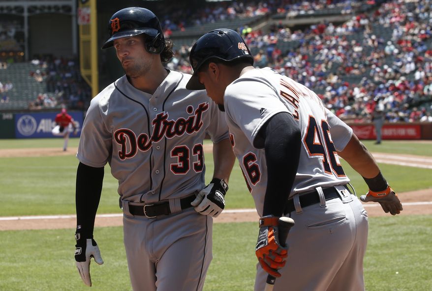 Detroit Tigers' Pete Kozma (33) is congratulated by Jeimer Candelario (46) after hitting a solo home run against the Texas Rangers during the third inning of a baseball game Wednesday, May 9, 2018, in Arlington, Texas. (AP Photo/Mike Stone)