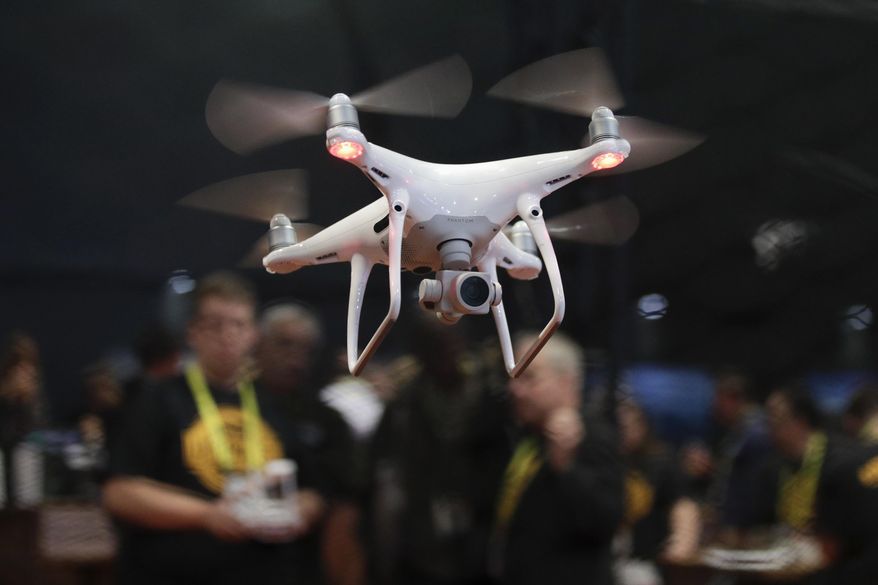 FILE - In this Jan. 5, 2017, file photo, an exhibitor demonstrates a drone flight at CES International in Las Vegas. On Wednesday, May 9, 2018, federal transportation officials announced 10 sites for a three-year drone program aimed at increasing government and commercial use of unmanned aircraft. The sites are located in Oklahoma, California, Nevada, North Dakota, North Carolina, Kansas, Alaska, Virginia, Tennessee and Florida. (AP Photo/Jae C. Hong, File)