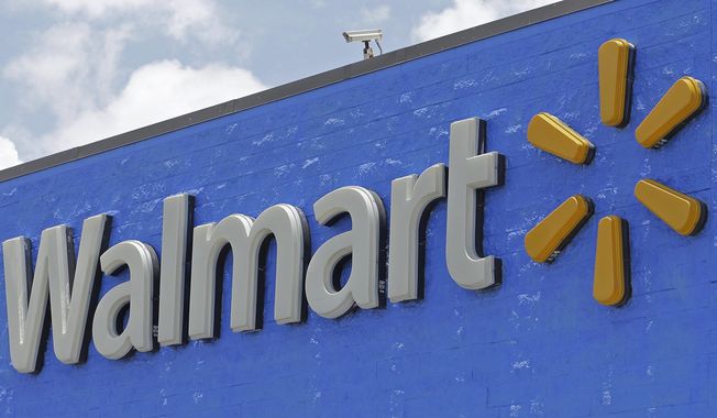 FILE - This June 1, 2017, file photo, shows a Walmart sign at a store in Hialeah Gardens, Fla. Walmart says it will pay about $16 billion for a majority stake in India’s leading e-commerce company Flipkart, giving the world’s largest retailer a formidable presence in a fast-growing economy. (AP Photo/Alan Diaz, File)