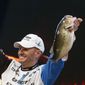 Randy Howell, Springville, Ala., holds up two bass at a weigh-in, Sunday Feb. 23, 2014 in Birmingham, Ala. that helped him win the Bassmaster Classic on Lake Guntersville. (AP Photo/Hal Yeager)