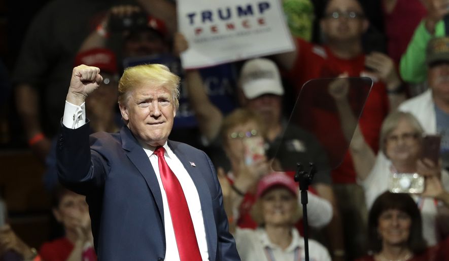 President Donald Trump acknowledges the crowd&#x27;s applause during a Republican campaign rally Thursday, May 10, 2018, in Elkhart, Ind. (AP Photo/Charles Rex Arbogast)