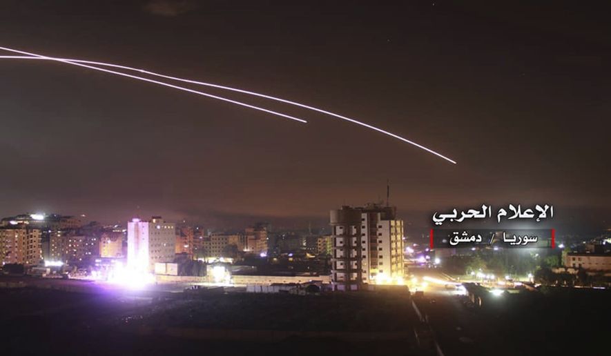 This photo provided early Thursday, May 10, 2018, by the government-controlled Syrian Central Military Media, shows missiles rise into the sky as Israeli missiles hit air defense position and other military bases, in Damascus, Syria. The Israeli military on Thursday said it attacked &quot;dozens&quot; of Iranian targets in neighboring Syria in response to an Iranian rocket barrage on Israeli positions in the Golan Heights, in the most serious military confrontation between the two bitter enemies to date. (Syrian Central Military Media, via AP)