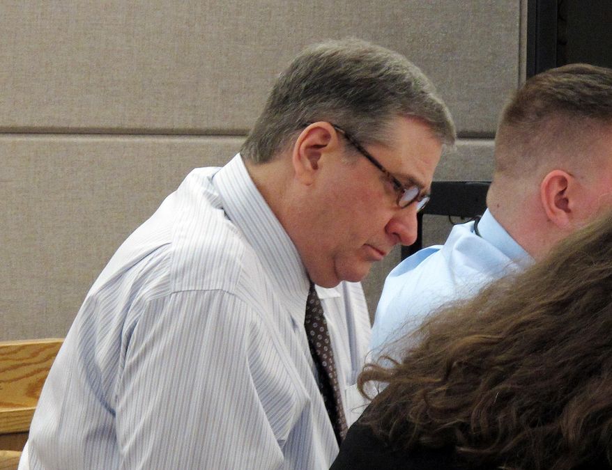 Mark Desimone, a former Arizona legislator charged with killing a man on an Alaska hunting and fishing trip in 2016, looks over documents during his trial in Juneau, Alaska, Thursday, May 10, 2018. Deborah Macaulay, who represents Desimone, said Thursday the shooting was an accident, not murder. (AP Photo/Becky Bohrer)
