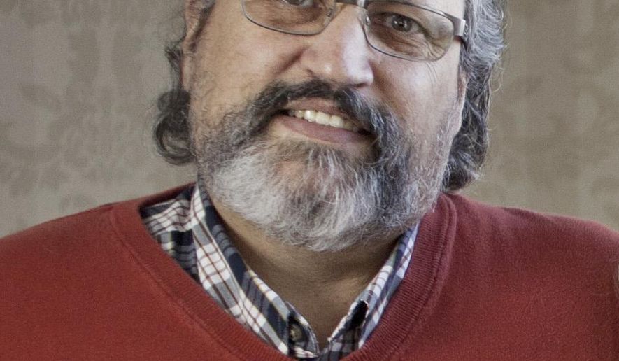 In this 2015 photo, Jack Woodburn, a Colonial Woods Christian Counseling Center director, poses in Port Huron, Mich. Woodburn is facing charges of coercion and enticement, access with intent to view and receipt of child pornography and producing or attempting to produce child pornography, according to a criminal complaint filed Tuesday, May 8, 2018 in federal court. (Jeffrey M. Smith/Port Huron Times Herald via AP)