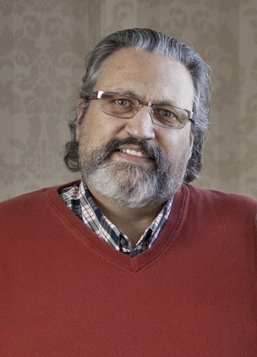In this 2015 photo, Jack Woodburn, a Colonial Woods Christian Counseling Center director, poses in Port Huron, Mich. Woodburn is facing charges of coercion and enticement, access with intent to view and receipt of child pornography and producing or attempting to produce child pornography, according to a criminal complaint filed Tuesday, May 8, 2018 in federal court. (Jeffrey M. Smith/Port Huron Times Herald via AP)