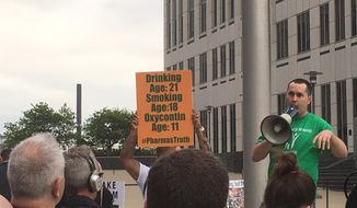 Mike Pack, of Akron, Ohio, speaks at a rally held by a coalition of groups seeking help in addressing the opioid crisis outside the federal courthouse in Cleveland on Thursday, May 10, 2018. The federal judge overseeing more than 600 lawsuits filed by government entities collectively seeking billions of dollars to address the nation’s opioid crisis said Thursday he will continue to push for solutions to the problem while lawyers continue their settlement talks.   (AP Photo/Mark Gillispie)