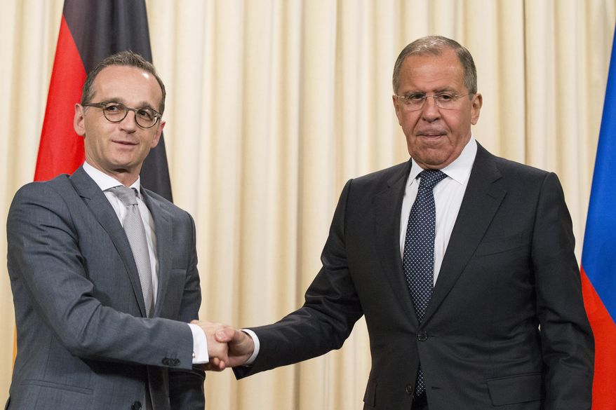 Russian Foreign Minister Sergey Lavrov, right, shakes hands with German Foreign Minister Heiko Maas after their joint news conference following the talks in Moscow, Russia, Thursday, May 10, 2018. (AP Photo/Alexander Zemlianichenko)