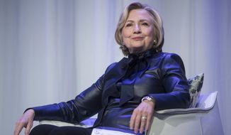 FILE - In this Wednesday, Dec. 13, 2017 file photo, Hillary Clinton sits on stage during a book tour event in Vancouver, British Columbia, Canada. On May 11, 2018, The Associated Press has found that stories circulating on the internet that Clinton is New Yorks new attorney general are untrue. (Darryl Dyck/The Canadian Press via AP)