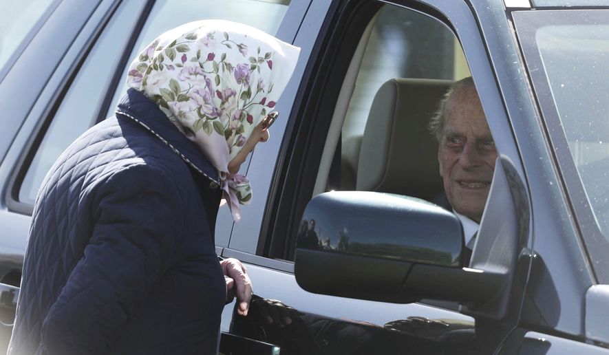 Britain's Queen Elizabeth II talks to Prince Philip The Duke of Edinburgh, during the Royal Windsor Horse Show in Windsor, England, Friday May 11, 2018. Prince Philip has made his first public appearance Friday since leaving hospital after his hip replacement operation, attending the Royal Windsor Horse Show.(Steve Parsons/PA via AP)