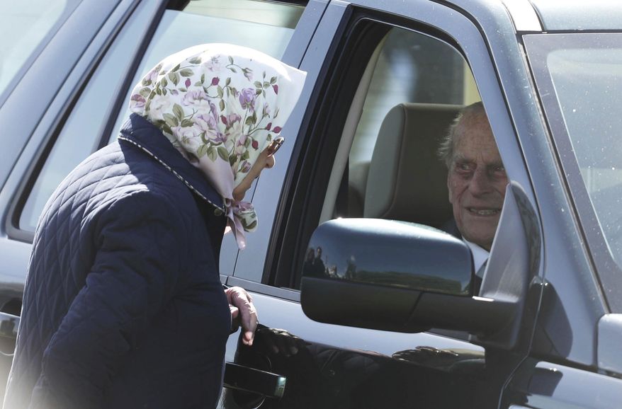 Britain's Queen Elizabeth II talks to Prince Philip The Duke of Edinburgh, during the Royal Windsor Horse Show in Windsor, England, Friday May 11, 2018. Prince Philip has made his first public appearance Friday since leaving hospital after his hip replacement operation, attending the Royal Windsor Horse Show.(Steve Parsons/PA via AP)