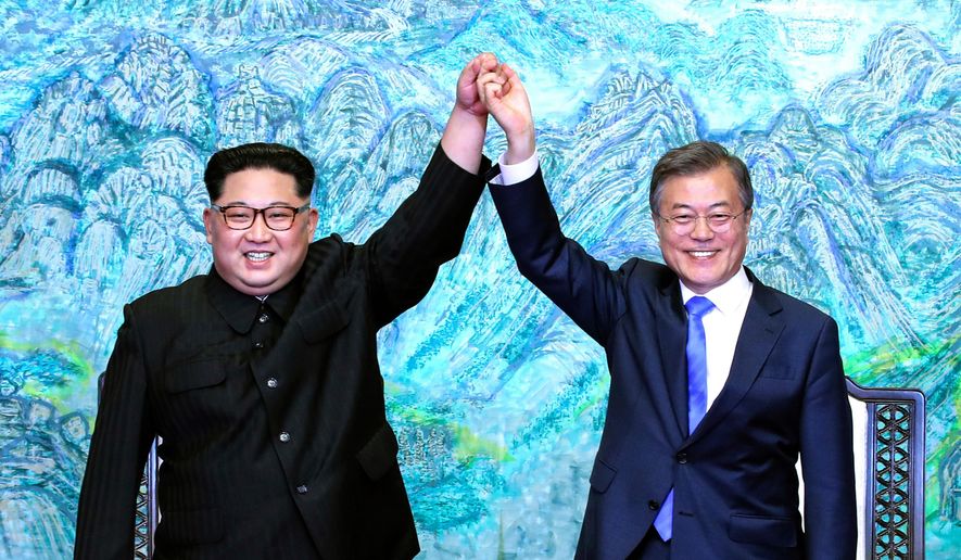 FILE - In this April 27, 2018, file photo, North Korean leader Kim Jong Un, left, and South Korean President Moon Jae-in raise their hands after signing a joint statement at the border village of Panmunjom in the Demilitarized Zone. Moon has stepped into the spotlight as he drives a new global push to settle the nuclear standoff with Pyongyang. (Korea Summit Press Pool via AP, File)