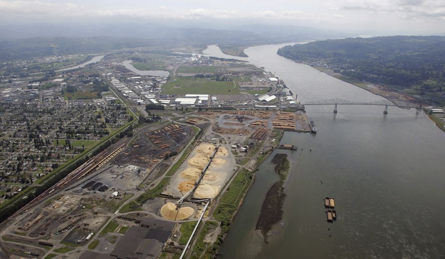 FILE--In this May 12, 2005, file photo, timber processing facilities line the banks of the Columbia River at Longview, Wash., near the Lewis and Clark Bridge. Six Western states and several national industry groups have lined up against Washington state in a legal battle over its decision to reject permits for a massive proposed coal-export terminal on the Columbia River. (AP Photo/Elaine Thompson, File)