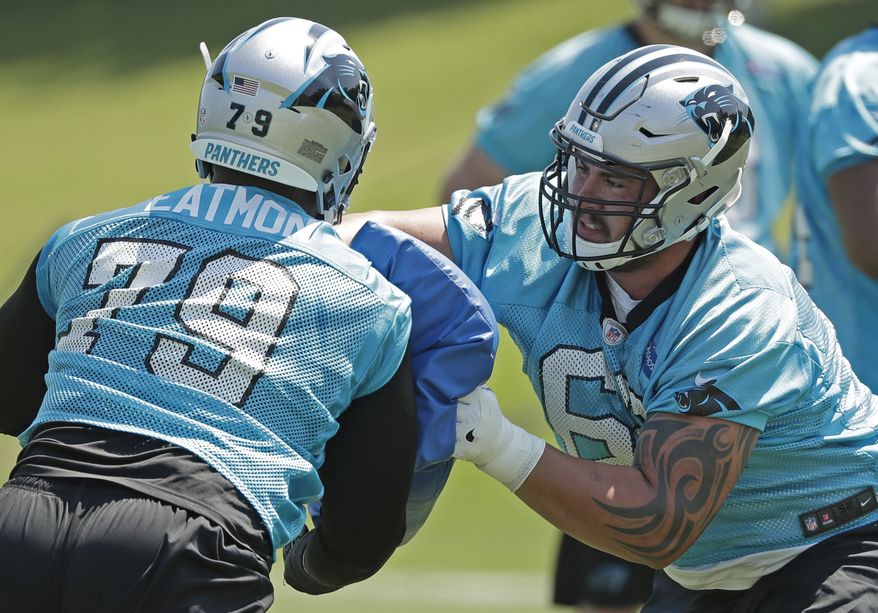 Carolina Panthers' Taylor Hearn (62) runs a drill against Quinterrius Eatmon (79) during the NFL football team's rookie camp in Charlotte, N.C., Saturday, May 12, 2018. (AP Photo/Chuck Burton)