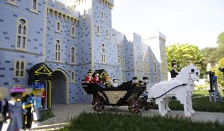 The newest attraction at Legoland in Windsor, England, Friday, May 11, 2018 shows a depiction of the upcoming wedding of Prince Harry and Meghan Markle outside Windsor Castle. All roads seem to lead to Windsor Castle, a magnificent fortress perched high on a hill topped by the royal standard when the queen is in residence. It is here — a favoured royal playground since William the Conqueror built the first structure here in 1070 — that the royal wedding of Prince Harry and Meghan Markle will take place. (AP Photo/Alastair Grant)