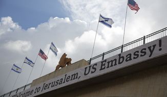 A sign on a bridge leading to the US Embassy compound ahead the official opening in Jerusalem, Sunday, May 13, 2018. Monday&#39;s opening of the U.S. Embassy in contested Jerusalem, cheered by Israelis as a historic validation, is seen by Palestinians as an in-your-face affirmation of pro-Israel bias by President Donald Trump and a new blow to frail statehood dreams. (AP Photo/Ariel Schalit)