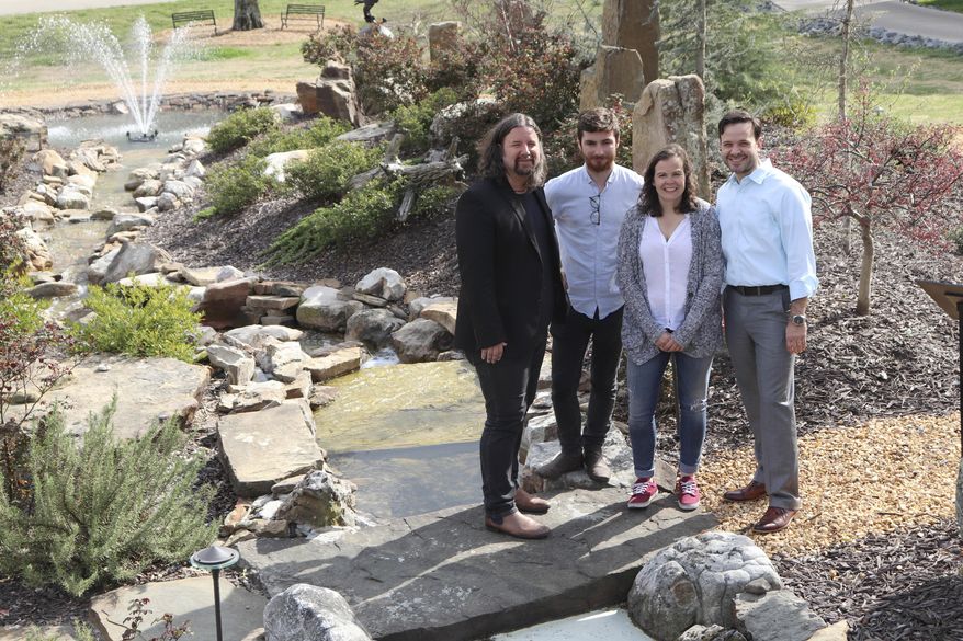 In this March 26, 2018, photo, researchers from the University of Sussex in England and the director of business strategy at Alliance Rubber, Jason Risner, pose for a photo in Hot Springs, Ark., where they met to discuss attempts to infuse rubber with graphene. Graphene would give rubber bands electrical and thermal properties for their potential use in the health care and agriculture industries. From left to right are Alan Dalton, an experimental physics professor at Sussex; Sussex researcher Sean Ogilvie; Alice King, a lecturer in applied materials and interfaces; and Risner. (AP Photo/Kelly P. Kissel)