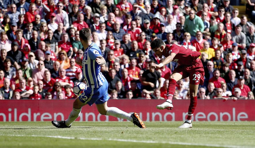 Liverpool's Dominic Solanke, right, scores his side's third goal of the game during their English Premier League soccer match at Anfield, Liverpool, England, Sunday, May 13, 2018. (Dave Thompson/PA via AP)