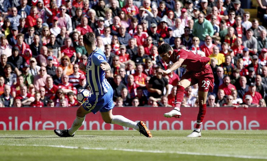 Liverpool's Dominic Solanke, right, scores his side's third goal of the game during their English Premier League soccer match at Anfield, Liverpool, England, Sunday, May 13, 2018. (Dave Thompson/PA via AP)