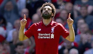 Liverpool&#x27;s Mohamed Salah celebrates scoring his side&#x27;s first goal of the game during their English Premier League soccer match against Brighton &amp;amp; Hove Albion at Anfield, Liverpool. England, Sunday, May 13, 2018. (Dave Thompson/PA via AP)