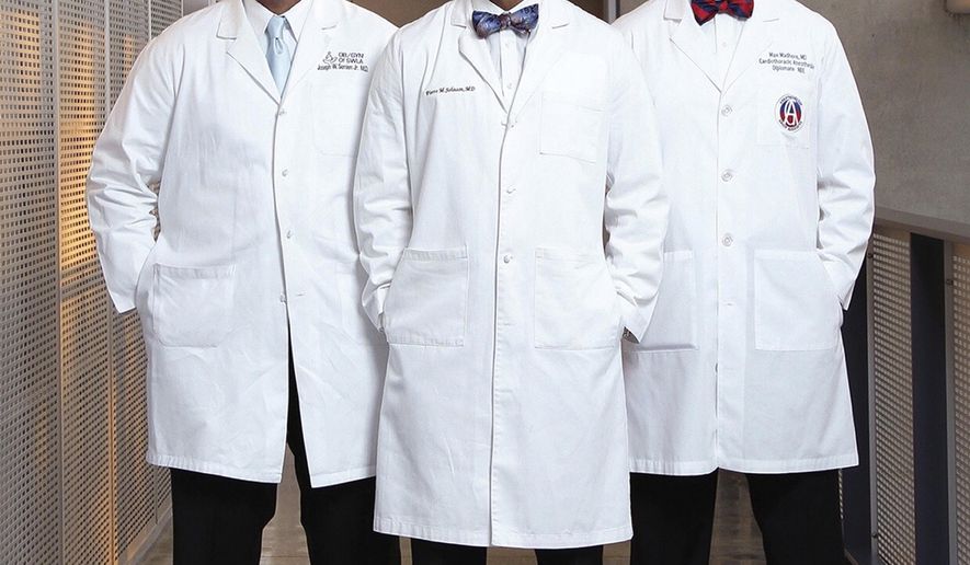This undated handout photo provided by Aaron Cormier shows Joseph Semien, Jr., from left, Pierre Johnson and Maxime Madhere on their book called "Pulse of Perseverance: Three Black Doctors on Their Journey to Success." When the three young black men entered Xavier University of Louisiana in 1998 to become doctors, they knew the odds were stacked against them. Still, they banded together and pushed each other, first through their pre-med classes at the nation's only historically black Catholic institution and later through medical school and beyond. (Aaron Cormier via AP)