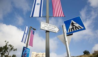A road sign leading to the U.S. Embassy is seen ahead the official opening in Jerusalem, Sunday, May 13, 2018. Monday&#x27;s opening of the U.S. Embassy in contested Jerusalem, cheered by Israelis as a historic validation, is seen by Palestinians as an in-your-face affirmation of pro-Israel bias by President Donald Trump and a new blow to frail statehood dreams. (AP Photo/Ariel Schalit)