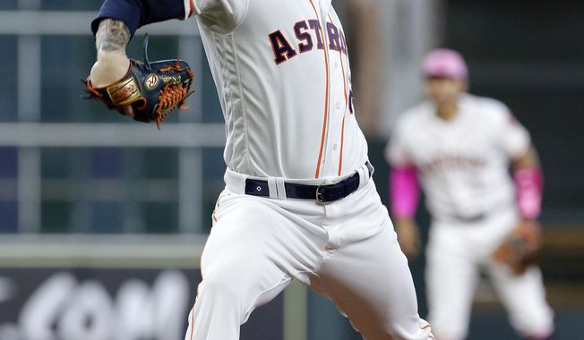 Houston Astros starting pitcher Dallas Keuchel throws against the Texas Rangers during the first inning of a baseball game Sunday, May 13, 2018, in Houston. (AP Photo/Michael Wyke)