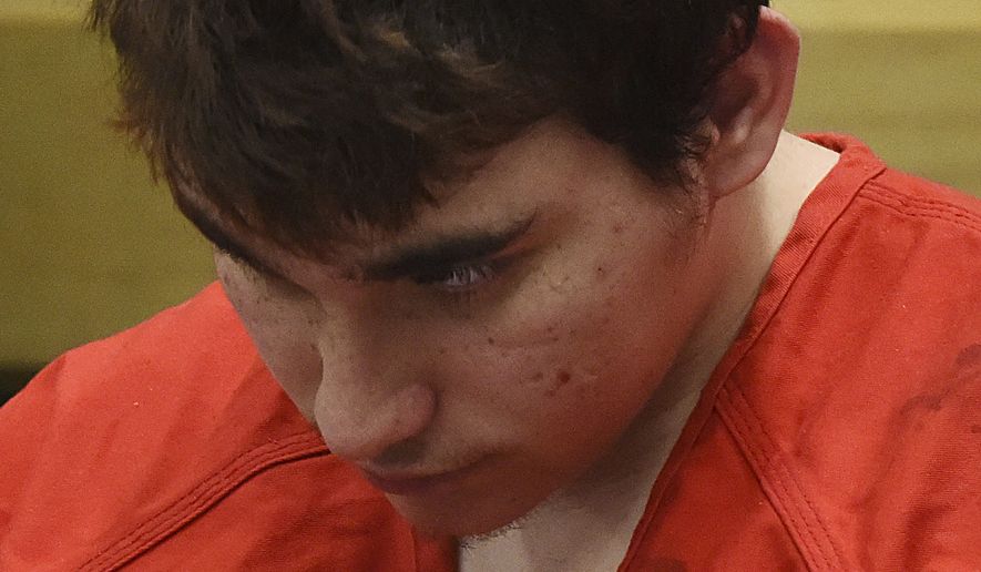 Florida school shooting suspect Nikolas Cruz, looks up while in court for a hearing in Fort Lauderdale, Fla., Friday, April 27, 2018. The hearing is expected to deal with several procedural issues possibly including setting an initial trial date.  Cruz is charged with 17 counts of murder and 17 counts of attempted murder in the Feb. 14, 2018 school shooting at Marjory Stoneman Douglas High School in Parkland, Fla. (Taimy Alvarez South Florida Sun-Sentinel via AP, POOL)