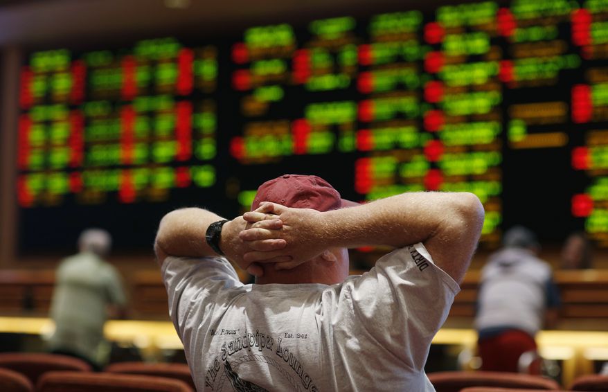 A man watches a baseball game in the sports book at the South Point hotel-casino, Monday, May 14, 2018, in Las Vegas. The Supreme Court on Monday gave its go-ahead for states to allow gambling on sports across the nation, striking down a federal law that barred betting on football, basketball, baseball and other sports in most states. (AP Photo/John Locher) **FiLE**