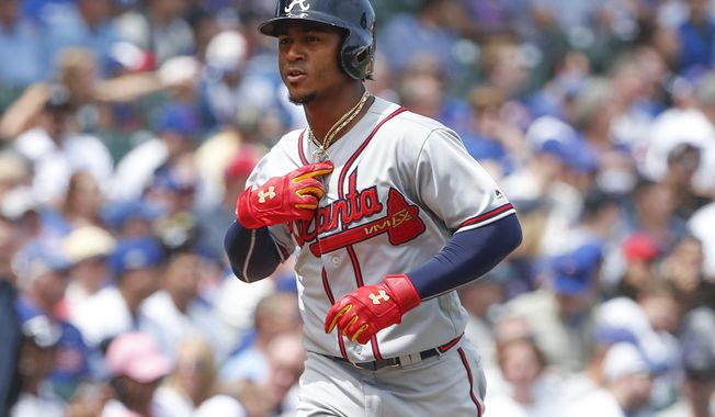 Atlanta Braves&#x27; Ozzie Albies rounds the bases after hitting a solo home run off Chicago Cubs&#x27; Jose Quintana during the first inning of a baseball game, Monday, May 14, 2018, in Chicago. (AP Photo/Kamil Krzaczynski)