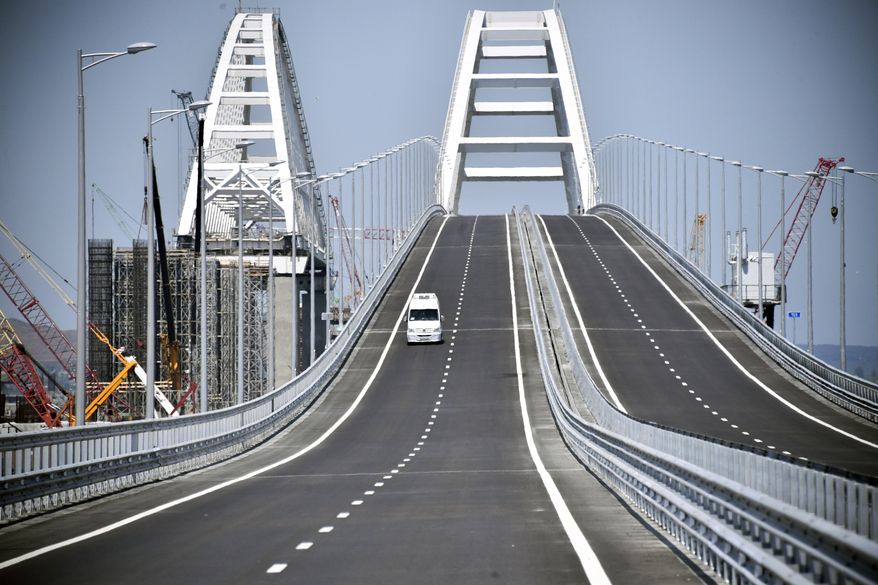 A view of the new bridge linking Russia and the Crimean peninsula prior to its opening ceremony near Kerch, Crimea, Tuesday, May 15, 2018. Russian President Vladimir Putin will attend the opening ceremony of the bridge. (Alexander Nemenov/Pool Photo via AP)