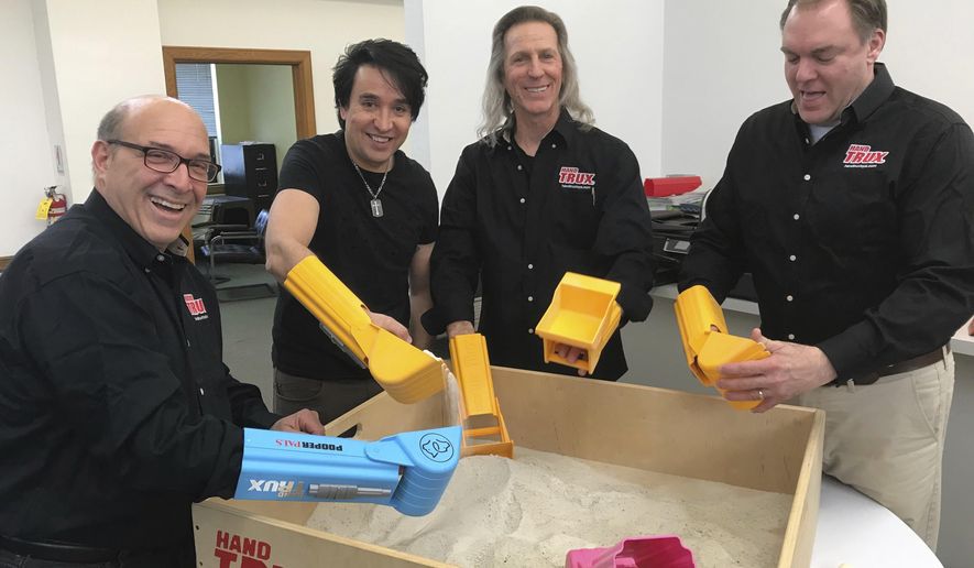 The Hand Trux team, left-right, David Fingerroth, Jorge Anunciacao, Ernest Van Den Heuvel, John Romano are shown Tuesday, May 15, 2018, in Little Falls, N.J.. Van Den Heuvel's toy story began on a construction site as he was operating a backhoe. The idea, he said, came to him in a flash. What if, he thought, kids could become a backhoe, or a dump truck, or a bulldozer, with a plastic toy they would wear on their hands like a glove? (Joan Verdon/The Record via AP)