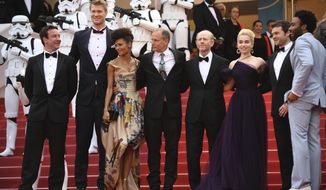 Actors Donald Glover, from right, Alden Ehrenreich, Emilia Clarke, director Ron Howard, actors Woody Harrelson, Thandie Newton, and Joonas Suotamo pose for photographers upon arrival at the premiere of the film &#39;Solo: A Star Wars Story&#39; at the 71st international film festival, Cannes, southern France, Tuesday, May 15, 2018. (Photo by Arthur Mola/Invision/AP)
