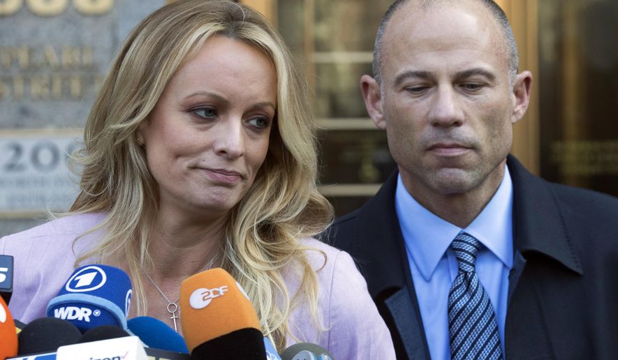 In this April 16, 2018 file photo, adult film actress Stormy Daniels, whose given name is Stephanie Clifford, and her attorney Michael Avenatti talk to reporters outside federal court in New York City. The hundreds of thousands of dollars that Stormy Daniels raised in her legal case against President Donald Trump came from an online crowdfunding site. But the unusual method of online fundraising for legal fees raises transparency questions about who is actually supporting the legal fight. Daniels and her attorney, Michael Avenatti, have raised more than $490,000 on the website CrowdJustice.com. (AP Photo/Mary Altaffer, File)