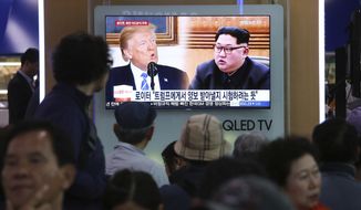 People watch a TV screen showing file footage of U.S. President Donald Trump, left, and North Korean leader Kim Jong Un during a news program at the Seoul Railway Station in Seoul, South Korea, Wednesday, May 16, 2018. North Korea on Wednesday threatened to scrap a historic summit next month between its leader, Kim Jong-un, and U.S. President Donald Trump, saying it has no interest in a &quot;one-sided&quot; affair meant to pressure Pyongyang to abandon its nuclear weapons. The signs read: &quot;Trying to test Trump.&quot; (AP Photo/Ahn Young-joon)