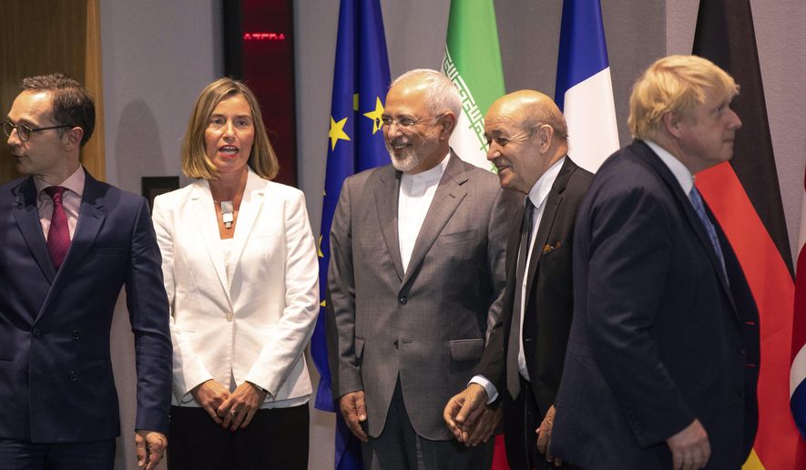 From left, German Foreign Minister Heiko Maa, European Union foreign policy chief Federica Mogherini, Iranian Foreign Minister Javad Zarif, French Foreign Minister Jean-Yves Le Dria, and Britain's Foreign Minister Boris Johnson prepare to pose for a photo during a meeting of the foreign ministers from Britain, France and Germany with the Iran Foreign Minister and EU foreign policy chief Federica Mogherini, at the Europa building in Brussels, Tuesday, May 15, 2018. Major European powers sought Tuesday to keep Iran committed to a deal to prevent it from building a nuclear bomb despite deep misgivings about Tehran's Middle East politics and President Donald Trump's vehement opposition. (AP Photo/Olivier Matthys, Pool)