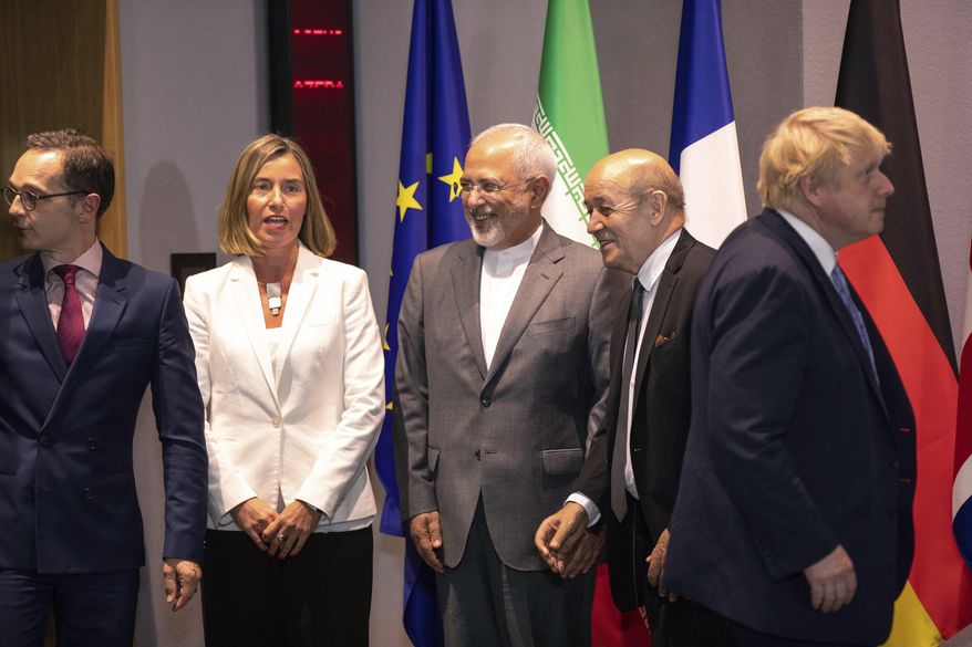 From left, German Foreign Minister Heiko Maa, European Union foreign policy chief Federica Mogherini, Iranian Foreign Minister Javad Zarif, French Foreign Minister Jean-Yves Le Dria, and Britain's Foreign Minister Boris Johnson prepare to pose for a photo during a meeting of the foreign ministers from Britain, France and Germany with the Iran Foreign Minister and EU foreign policy chief Federica Mogherini, at the Europa building in Brussels, Tuesday, May 15, 2018. Major European powers sought Tuesday to keep Iran committed to a deal to prevent it from building a nuclear bomb despite deep misgivings about Tehran's Middle East politics and President Donald Trump's vehement opposition. (AP Photo/Olivier Matthys, Pool)