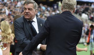 Everton manager Sam Allardyce, left, shakes hands with West Ham manager David Moyes, ahead of the English Premier League soccer match between West Ham United and Everton,  at the London Stadium, in London, Sunday May 13, 2018. (Daniel Hambury/PA via AP)