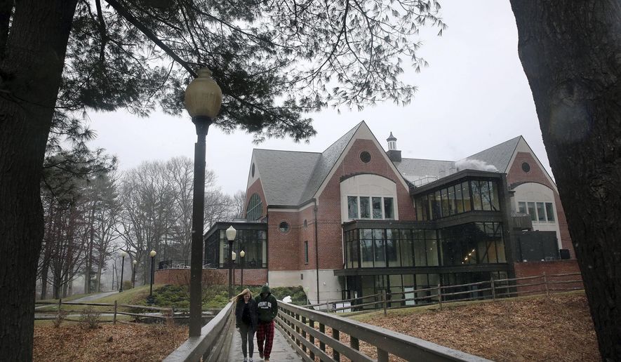 In this April 6, 2018, file photo, students walk on the campus of Mount Ida College in Newton, Mass. (Craig F. Walker/The Boston Globe via AP) ** FILE **
