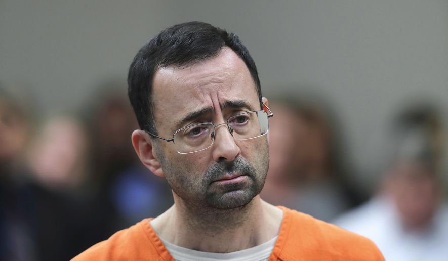 In this Nov. 22, 2017, file photo, Dr. Larry Nassar appears in court for a plea hearing in Lansing, Mich. Michigan State University has reached a $500 million settlement with hundreds of women and girls who say they were sexually assaulted by Nassar in the worst sex-abuse case in sports history. The deal was announced Wednesday, May 16, 2018, by Michigan State and lawyers for 332 victims. (AP Photo/Paul Sancya, File)