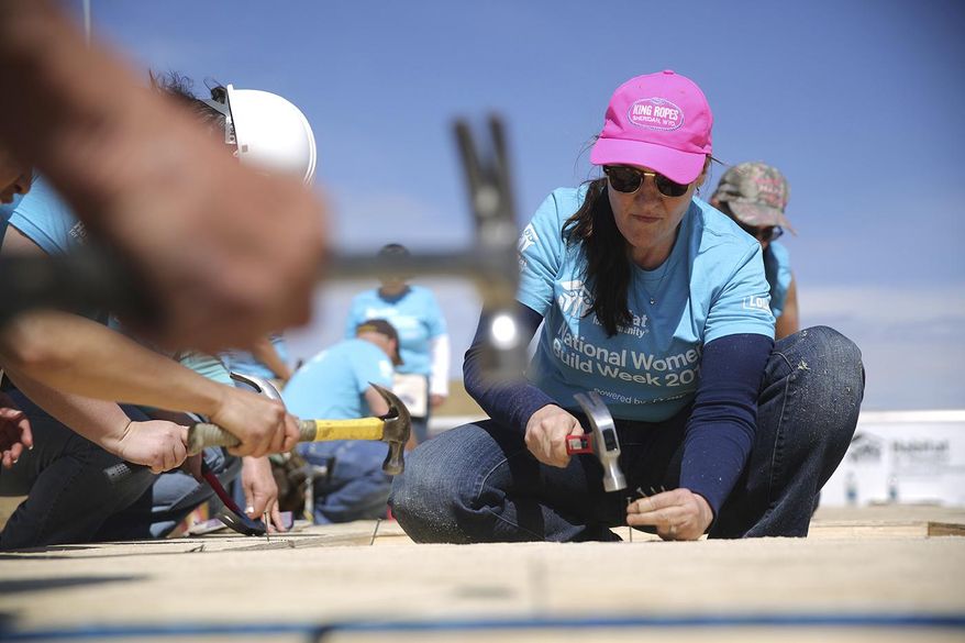 Shelly Good helps construct a Habitat for Humanity home Saturday, May 5, 2018 in Casper, Wyoming as part of National Women Build Week. (Josh Galemore, Casper Star-Tribune via AP)