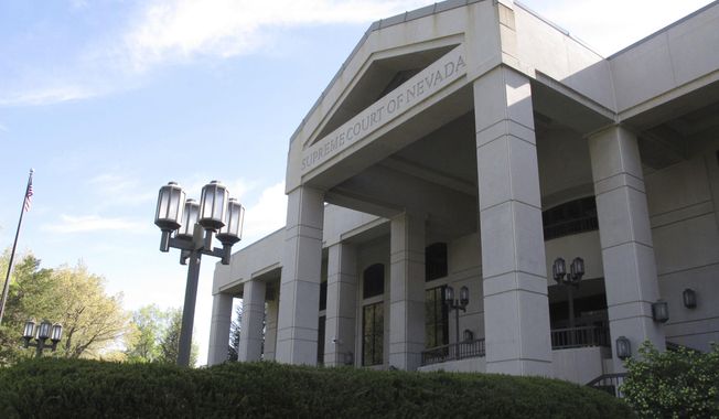 FILE - This May 8, 2018 file photo shows the Nevada Supreme Court in Carson City, Nev. A legal battle in Nevada over a proposed ballot initiative that seeks to ban so-called sanctuary cities is headed back to state court. In a 6-1 ruling Wednesday, May 16, 2018, the Nevada Supreme Court overturned part of a district court order that would keep the measure off the November ballot. But the justices say more changes are needed before it can go to the voters. (AP Photo/Scott Sonner, file)