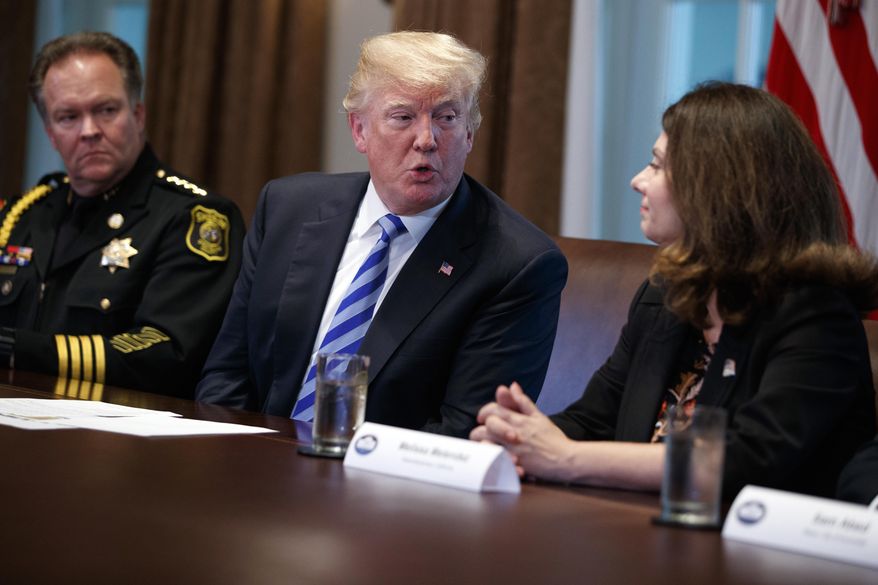 Stanislaus County Sheriff Adam Christianson, left, listensas President Donald Trump speaks to California Assemblywoman Melissa Melendez during a roundtable on immigration policy in California, in the Cabinet Room of the White House, Wednesday, May 16, 2018, in Washington. (AP Photo/Evan Vucci)