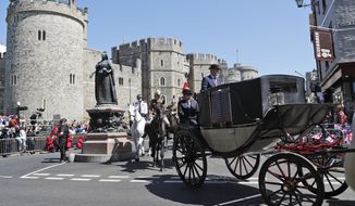 A carriage is driven through the streets of Windsor, England during a rehearsal for the procession of the upcoming wedding of Britain&#x27;s Prince Harry and Meghan Markle, Thursday, May 17, 2018. Preparations are being made in the town ahead of the wedding of Britain&#x27;s Prince Harry and Meghan Markle that will take place in Windsor on Saturday May 19.(AP Photo/Frank Augstein)