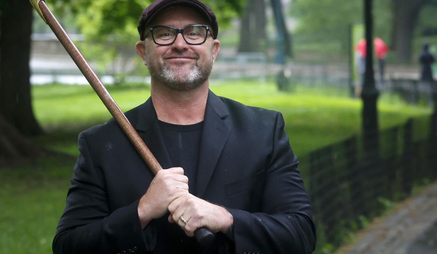 In this May 16, 2018 photo, retired Navy SEAL James Hatch poses with his walking cane in New York. Hatch is the author of "Touching the Dragon: And Other Techniques for Surviving Life's Wars," which was released on Tuesday. (AP Photo/Bebeto Matthews)