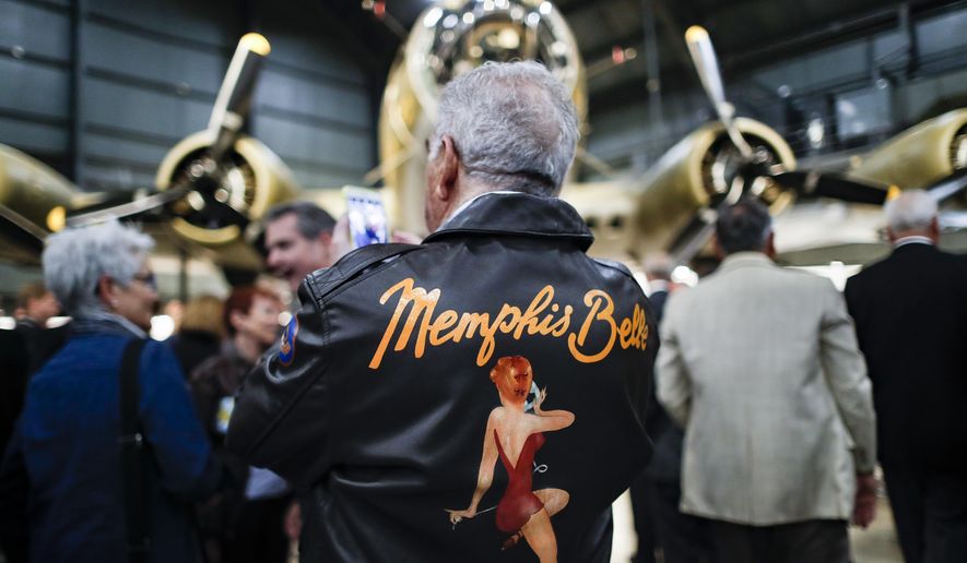Visitors gather for a private viewing of the Memphis Belle, a Boeing B-17 &amp;quot;Flying Fortress,&amp;quot; at the National Museum of the U.S. Air Force, Wednesday, May 16, 2018, in Dayton, Ohio. The World War II bomber Memphis Belle is set to go on display for the first time since getting a yearslong restoration at the museum. The B-17 “Flying Fortress” will be introduced Thursday morning as the anchor of an extensive exhibit in the Dayton-area museum’s World War II gallery. (AP Photo/John Minchillo)