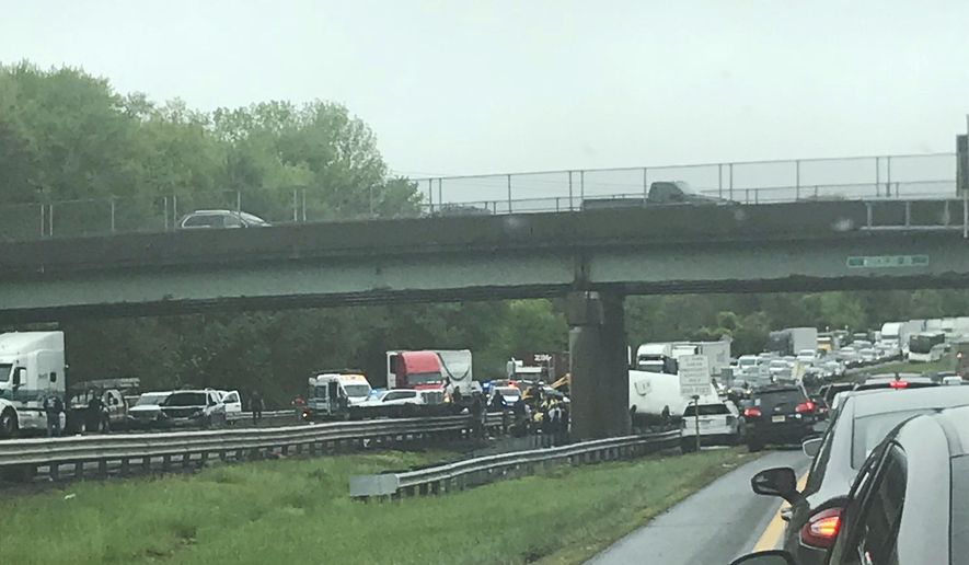 Emergency personnel respond to a crash after a school bus and dump truck collided in Mount Olive, N.J., Thursday, May 17, 2018. (Jay Faltings via AP)