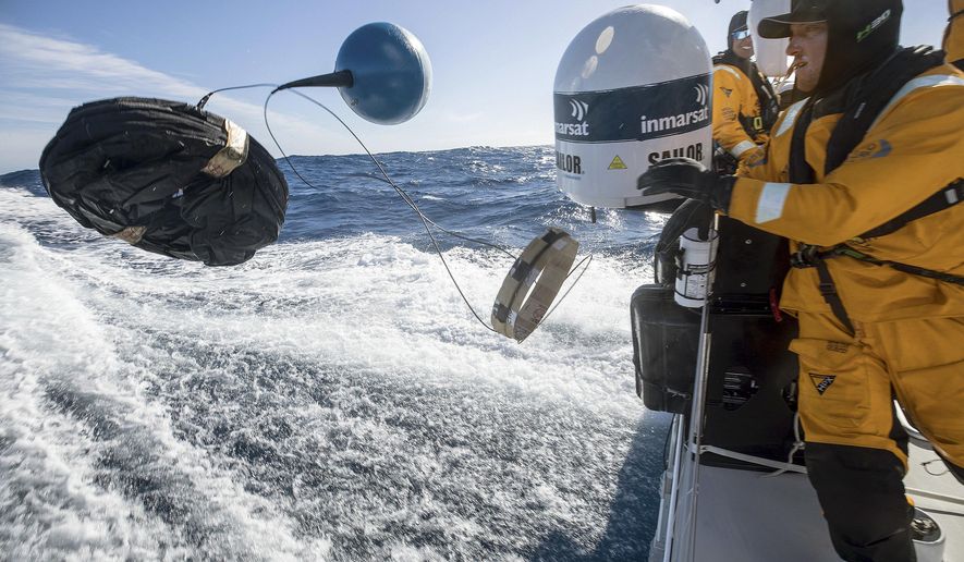 In this March 21, 2018 photo provided by Volvo Ocean Race, Frederico de Melo deploys a scientific drifter to test the water for evidence of pollution in the Pacific Ocean from aboard the vessel "Turn the Tide on Plastic," during the race leg from New Zealand to Brazil. For the sailors, teams, organizers and sponsors, the Volvo Ocean Race is part of a larger race against time, a mission to curb the use of products that litter the ocean and befoul the air. (Sam Greenfield/Volvo Ocean Race via AP)